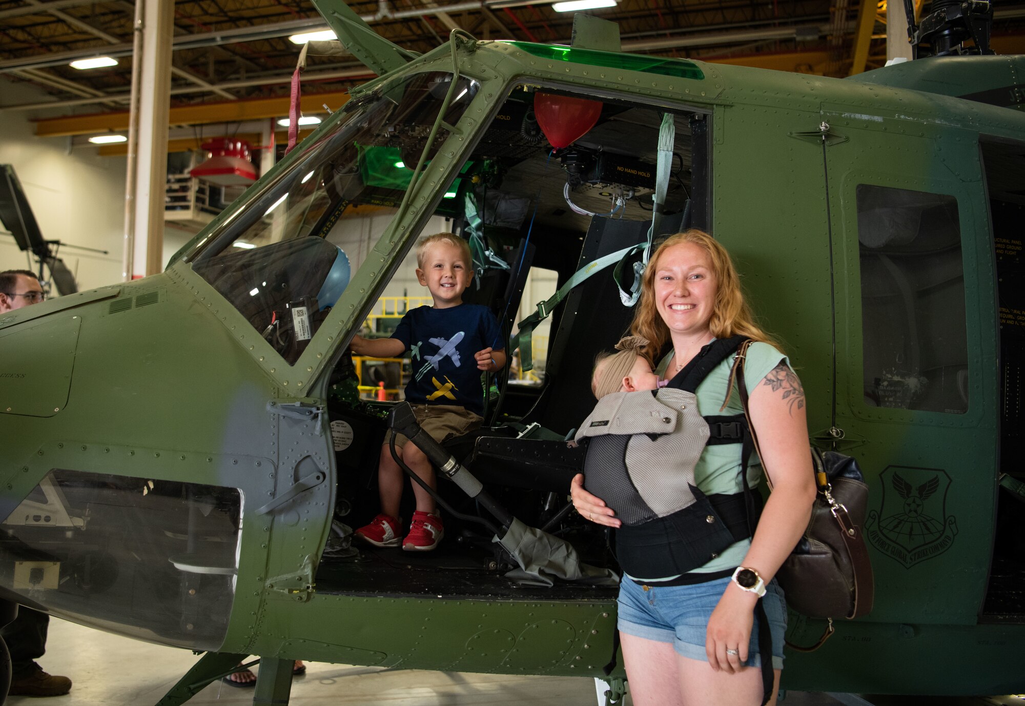 Wyatt, 3, and his mother Kaylee explore a UH-1N Huey at F. E. Warren Air Force Base, Wyoming, June 18, 2021. Dependents and family members were invited to visit various units across the base for the 90th Missile Wing Family Weekend activities. (U.S. Air Force photo by Jordan Pickett)