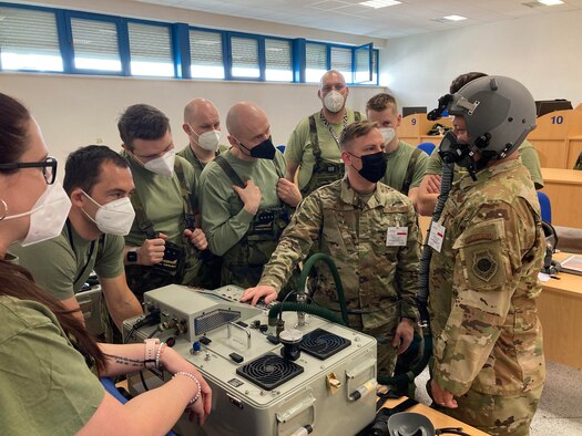 An Airman teaches Czechian Airmen about joint combined aircrew system tester systems.