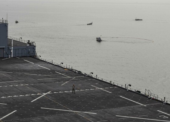 (JUNE 21, 2021) Senegalese fishermen haul in their nets as the Expeditionary Sea Base USS Hershel “Woody” Williams (ESB 4) steams by in the Atlantic Ocean, June 21, 2021. Hershel “Woody” Williams is on a scheduled deployment in the U.S. Sixth Fleet area of operations in support of U.S. national interests and security in Europe and Africa.