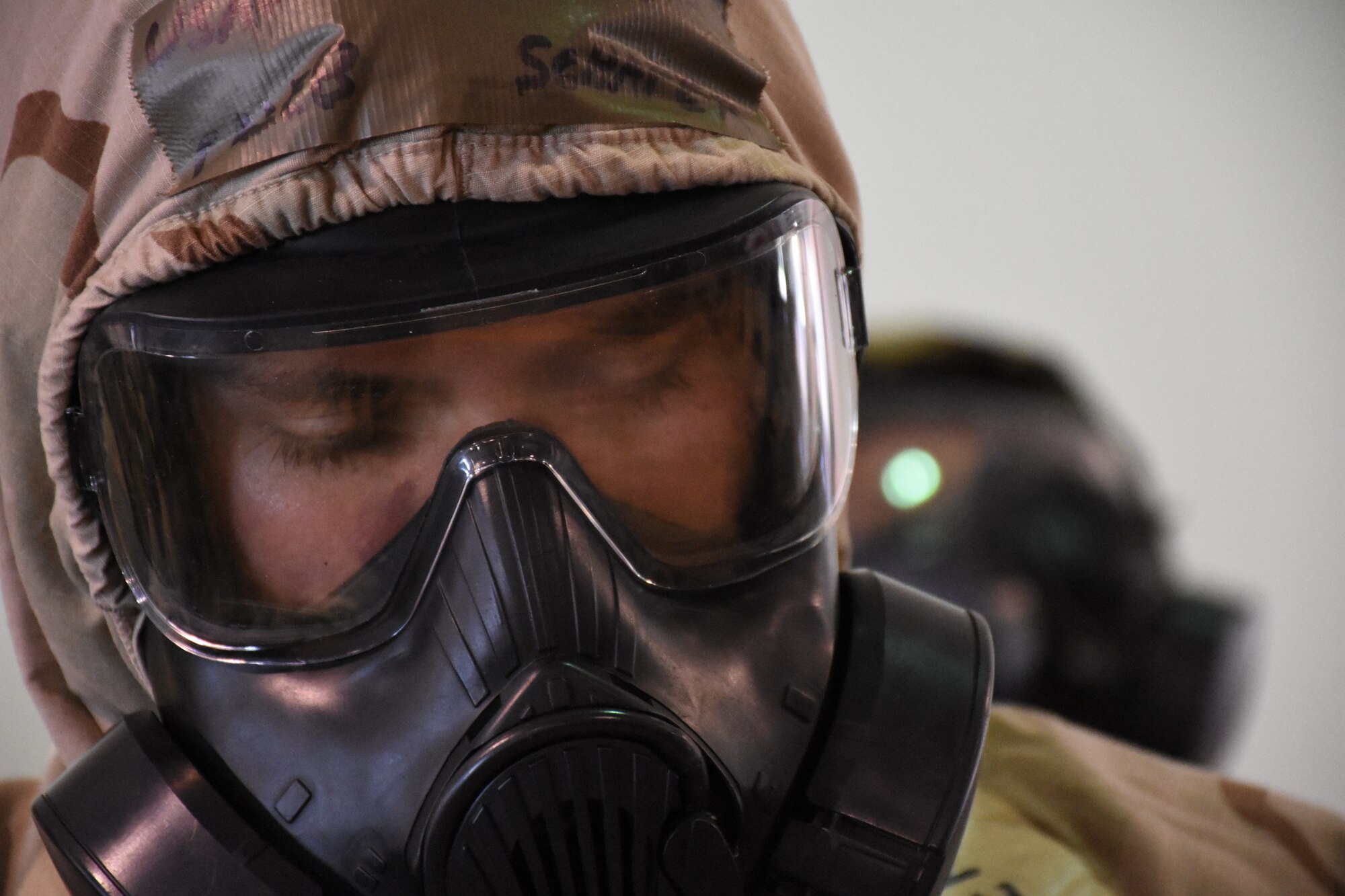 An Airman wears a gas mask.