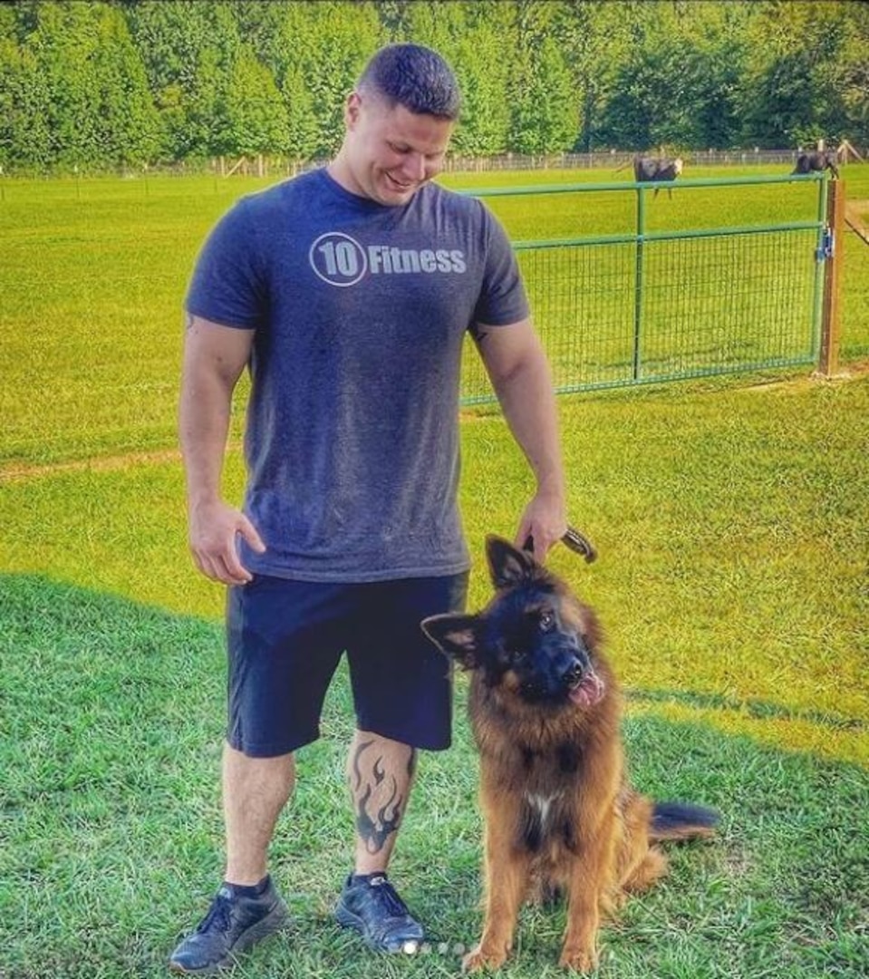 U.S. Air Force Tech. Sgt. William Kuryluk, 609th Expeditionary Communications Squadron, noncommissioned officer in charge of Radio Frequency Transmissions section, spends time with his Western Long Coat German Shepherd, Asher, after an outdoor fitness session. Kuryluk integrated his two-year old dog into his personal fitness plan when gym access became limited due to COVID-19. (Courtesy Photo)