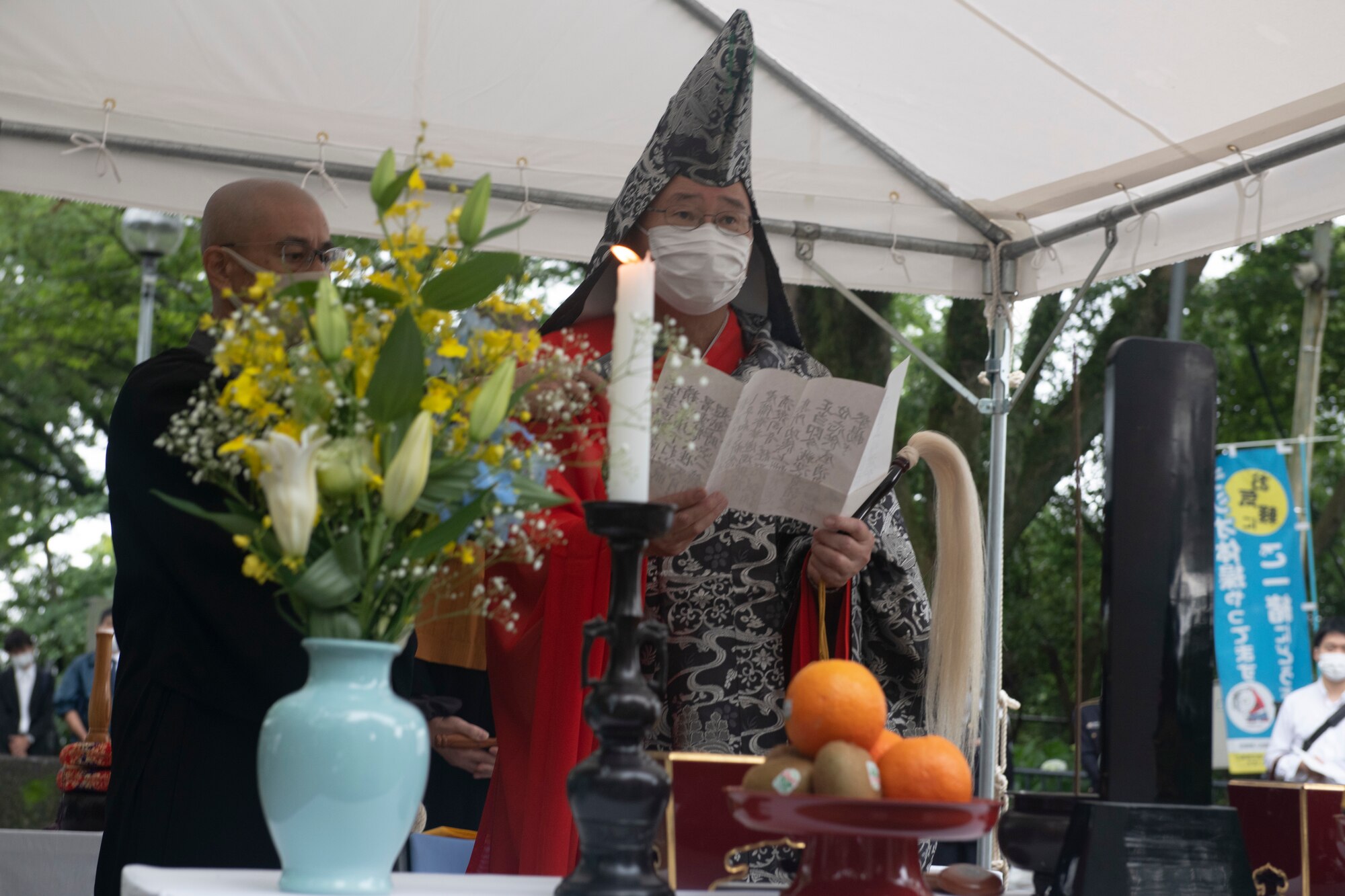 Kugen Yoshida, Shizuoka Sengen Shrine chief priest, right, reads a Buddhist chant during a memorial ceremony in Shizuoka City, Japan, June 19, 2021. The ceremony honored the individuals who died from a B-29 Superfortress collision and air raid with both Japanese and American traditions. (U.S. Air Force photo by Staff Sgt. Joshua Edwards)