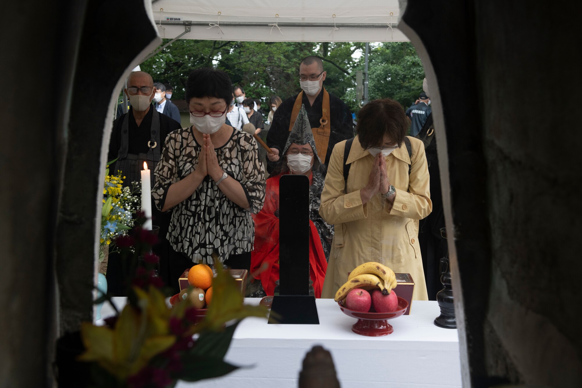 Misturu Takahasi, 374th Airlift Wing Public Affairs community relations civilian lead, and Itoe Iwasaki, Fukumatsu Itoh’s granddaughter, pray during a memorial ceremony in Shizuoka City, Japan, June 19, 2021. Itoh was a priest who came to the aid of U.S. service members after two B-29 Superfortesses collided and is the creator of the memorial ceremony. (U.S. Air Force photo by Staff Sgt. Joshua Edwards)