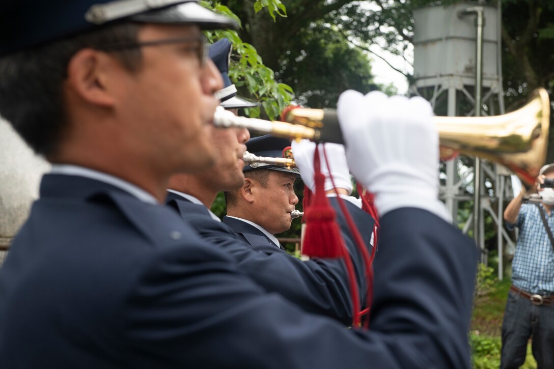 Japanese Self-Defense Force members play “Kuni no Shizume” during the memorial ceremony in Shizuoka City, Japan, June 19, 2021. Both U.S. and Japanese forces played their respective songs to pay tribute to the individuals who died during World War II. (U.S. Air Force photo by Staff Sgt. Joshua Edwards)
