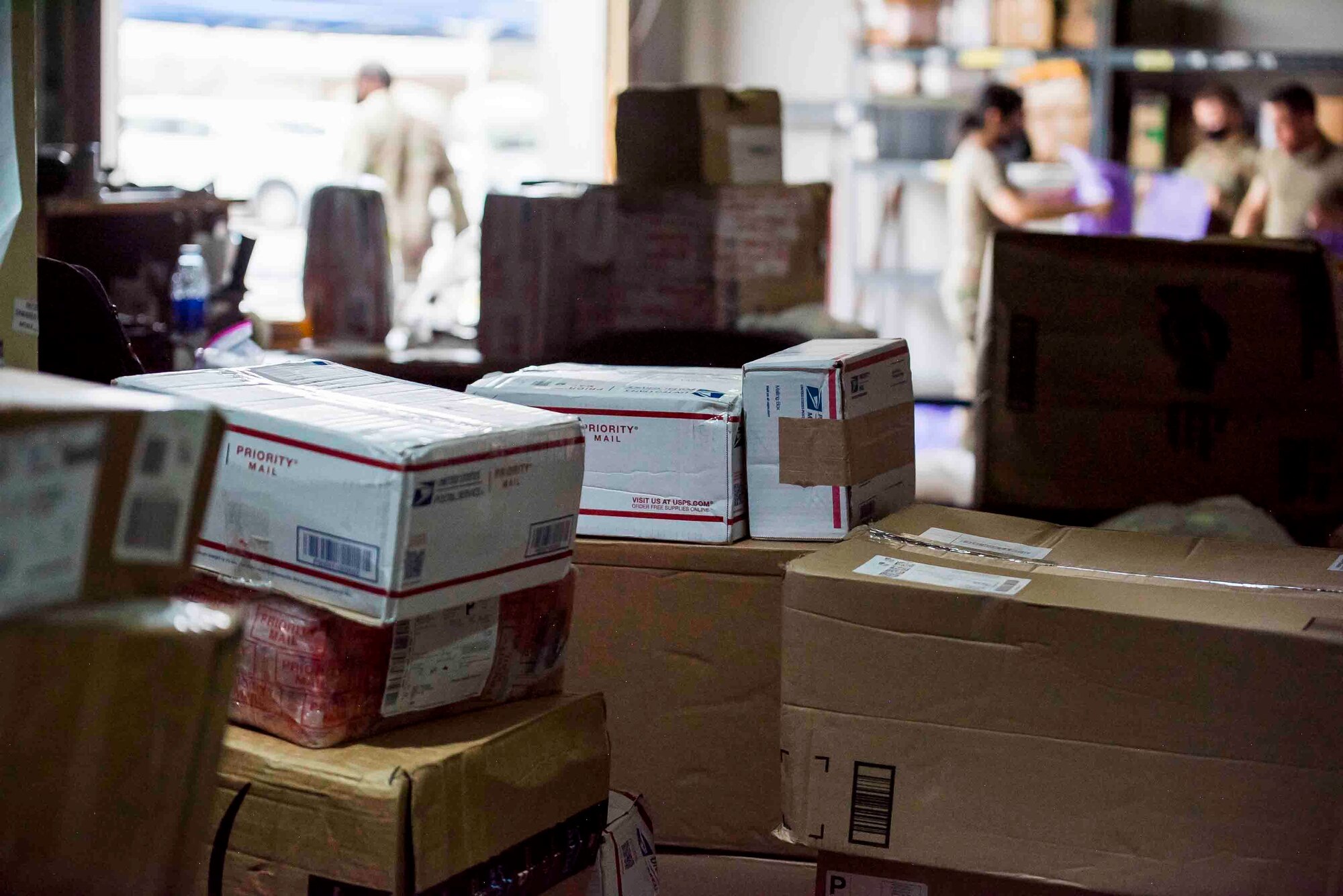 U.S. Air Force Airmen from the 380th Expeditionary Force Support Squadron, sort mail packages at Al Dhafra Air Base (ADAB), United Arab Emirates, June 16, 2021. The ADAB post office averages 52,000 lbs across 8,500 packages a month.