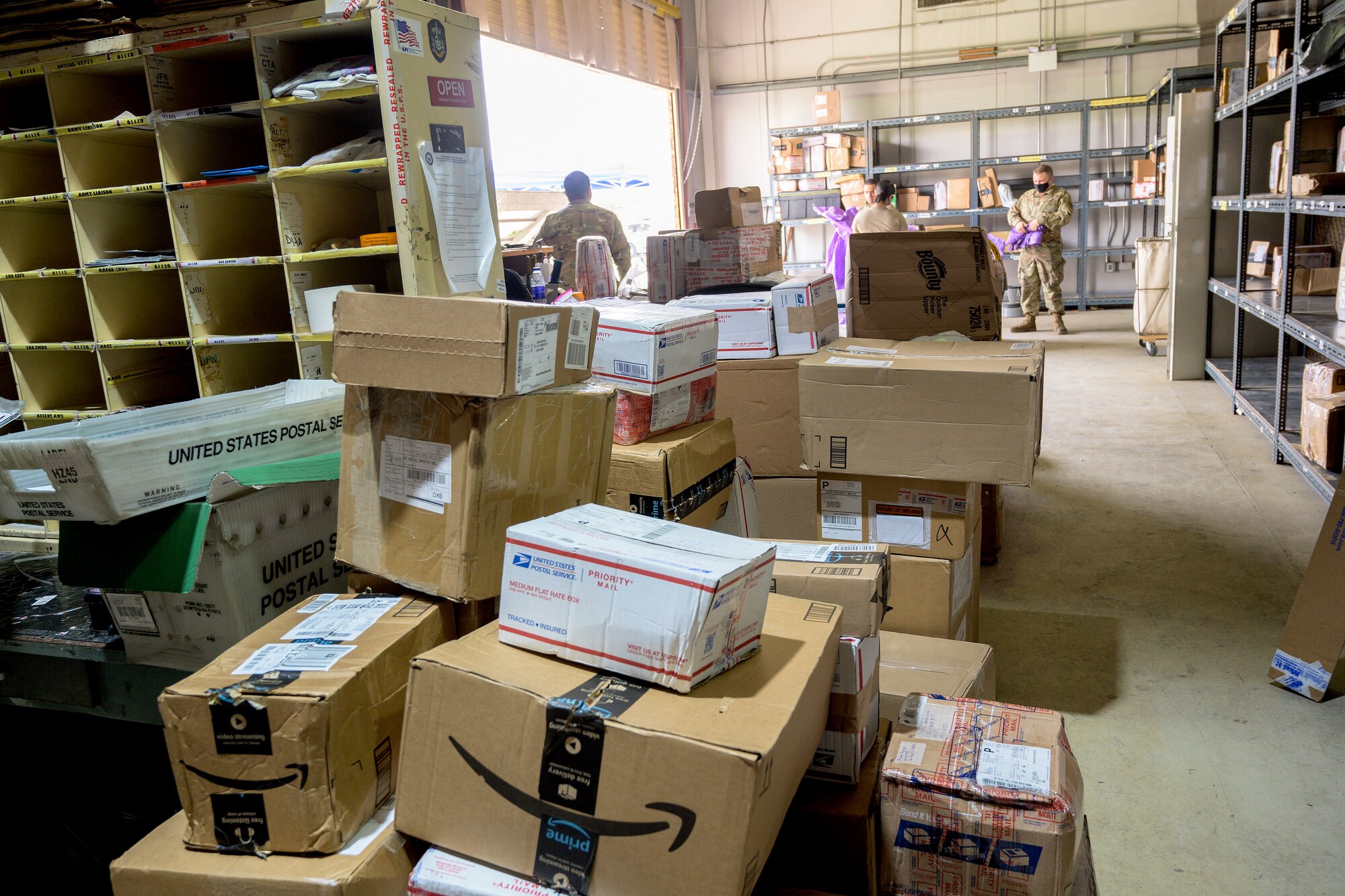 U.S. Air Force Airmen from the 380th Expeditionary Force Support Squadron, sort mail packages at Al Dhafra Air Base (ADAB), United Arab Emirates, June 16, 2021. The ADAB post office averages 52,000 lbs across 8,500 packages a month.