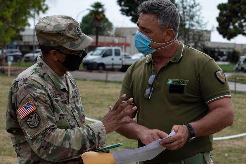 U.S. Army Reserve Sgt. Maj. Forrest McKinley, senior noncommissioned officer of the 2500th Digital Liaison Detachment, 7th Mission Support Command, left, develops the base access roster for his Soldiers with Italian Army Sgt. Maj. Giovanni Di Maio during exercise DEFENDER-Europe 21, in Capua, Italy, June 10, 2021. The 2500th DLD provided liaison capability between the U.S. Army´s V Corps and the Italian Army's Divisione Acqui.
