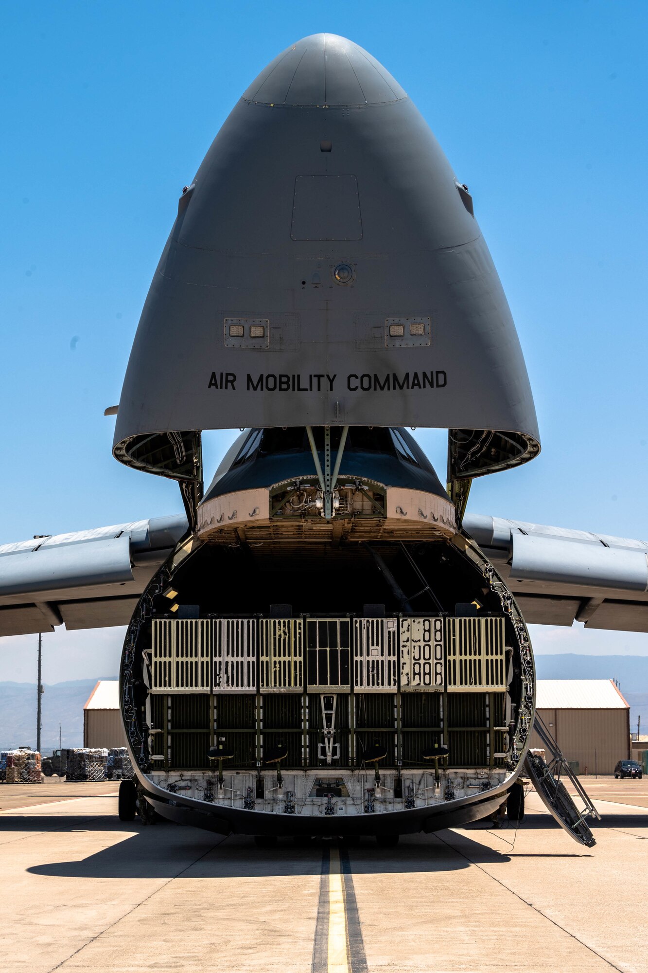 The visor of a Dover Air Force Base C-5M Super Galaxy is raised in preparation for an Engine Running Onload during a Major Command Service Tail Trainer at Holloman AFB, New Mexico, June 7, 2021. The 9th AS performs MSTTs to expedite upgrade and qualification training for C-5M loadmasters and flight engineers. (U.S. Air Force photo by Senior Airman Faith Schaefer)