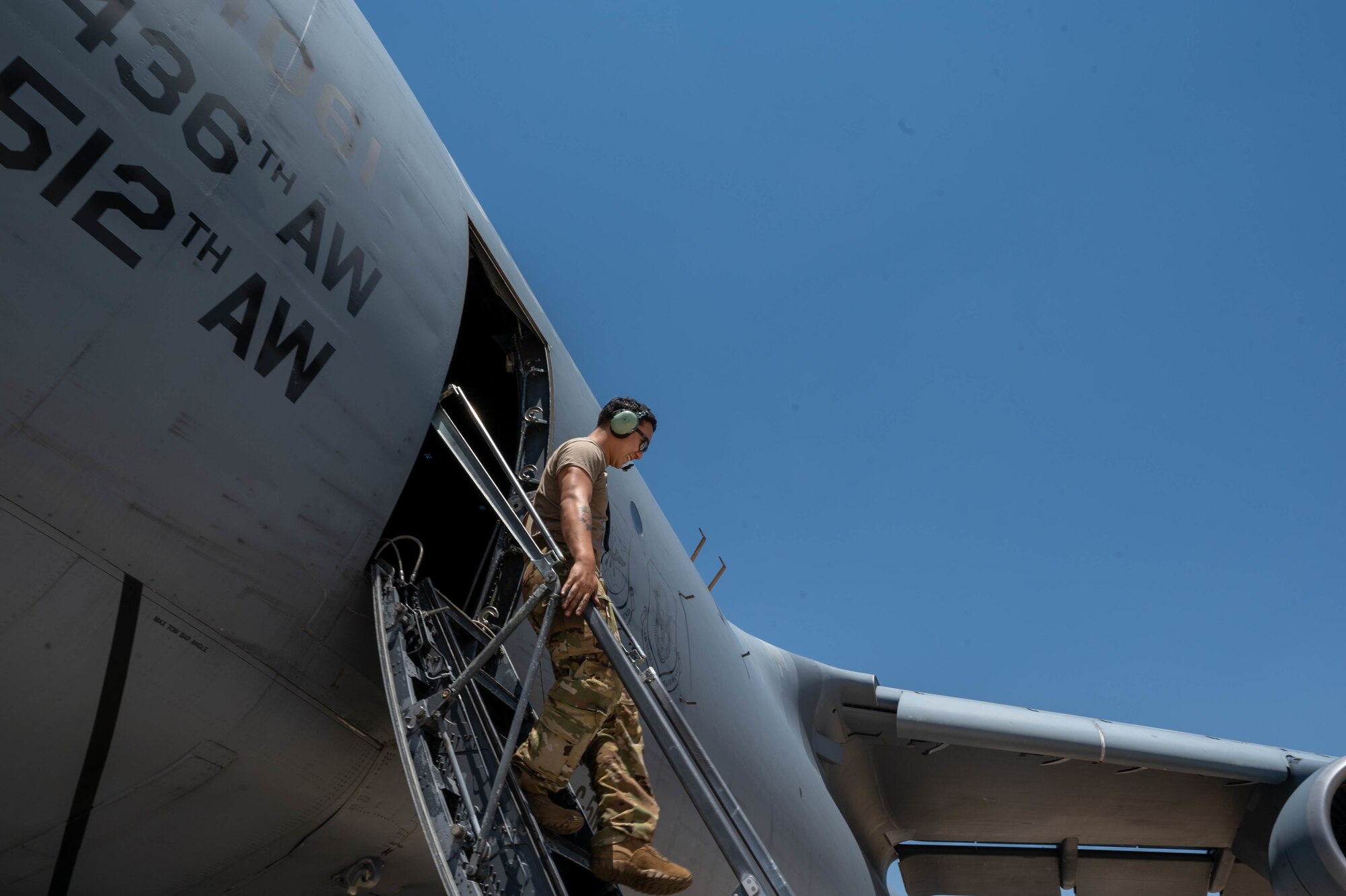 Staff Sgt. Alex Delamarter, 9th Airlift Squadron flight engineer student, climbs down the crew stairs of a Dover Air Force Base C-5M Super Galaxy during a Major Command Service Tail Trainer at Holloman AFB, New Mexico, June 7, 2021. The 9th AS performs MSTTs to expedite upgrade and qualification training for C-5M loadmasters and flight engineers. This MSTT was coordinated in partnership with Air Education Training Command’s 49th Wing and Air Force Materiel Command’s 635th Materiel Maintenance Group. (U.S. Air Force photo by Senior Airman Faith Schaefer)