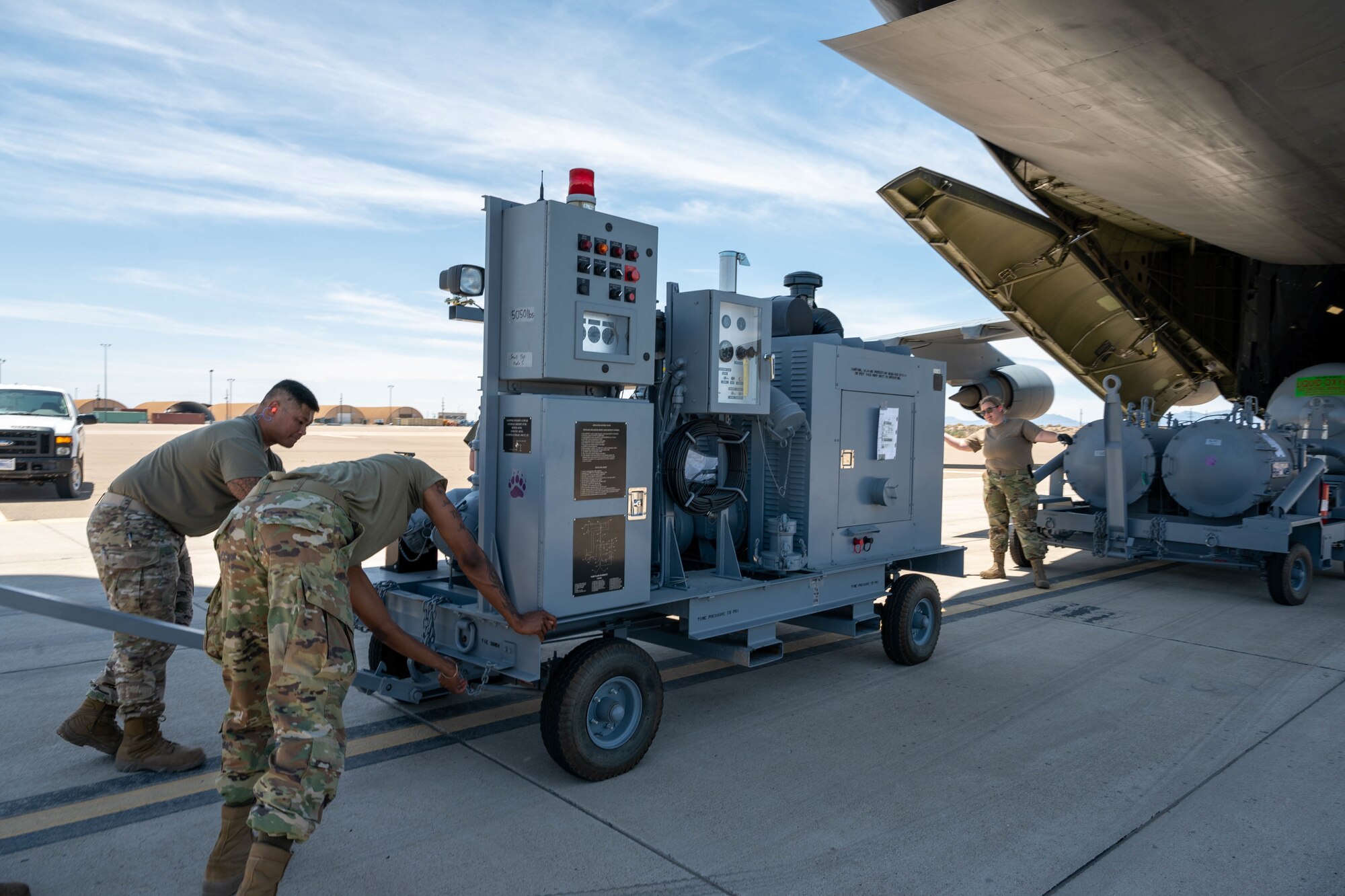 Airmen from the 49th Logistics Readiness Squadron load aircraft ground equipment onto a Dover Air Force Base C-5M Super Galaxy during a Major Command Service Tail Trainer, at Holloman AFB, New Mexico, June 8, 2021. Loadmasters from the 9th Airlift Squadron coordinated cargo with Airmen from Air Education and Training Command’s 49th Wing and Air Force Materiel Command’s 635th Materiel Maintenance Group to complete the 10-day MSTT. Over the course of the training, Airmen loaded and unloaded 320,085 pounds of cargo, including palletized cargo, AGE, a fuel truck and a K-loader. (U.S. Air Force photo by Senior Airman Faith Schaefer)