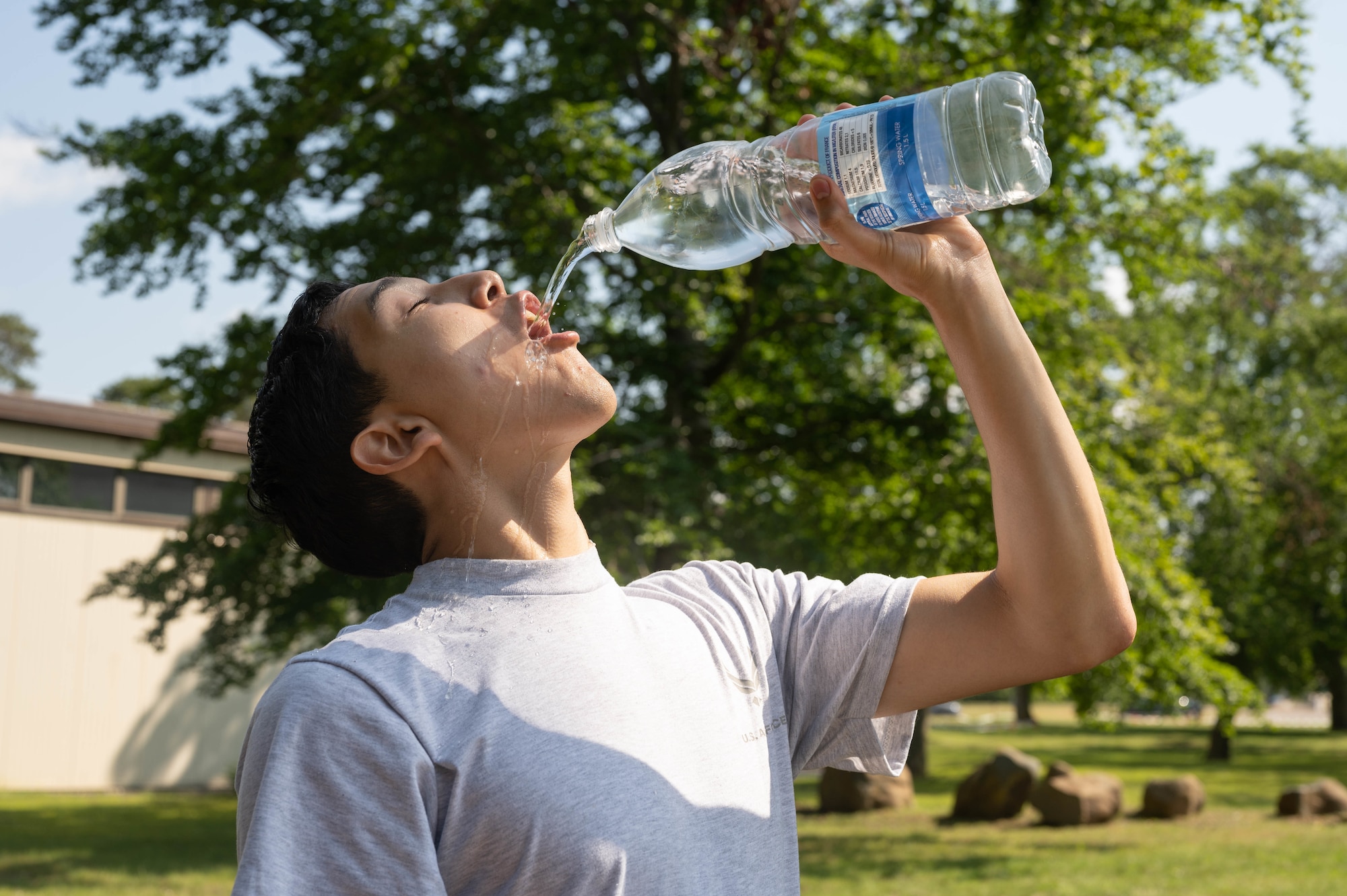 Young man waterfalls water bottle.