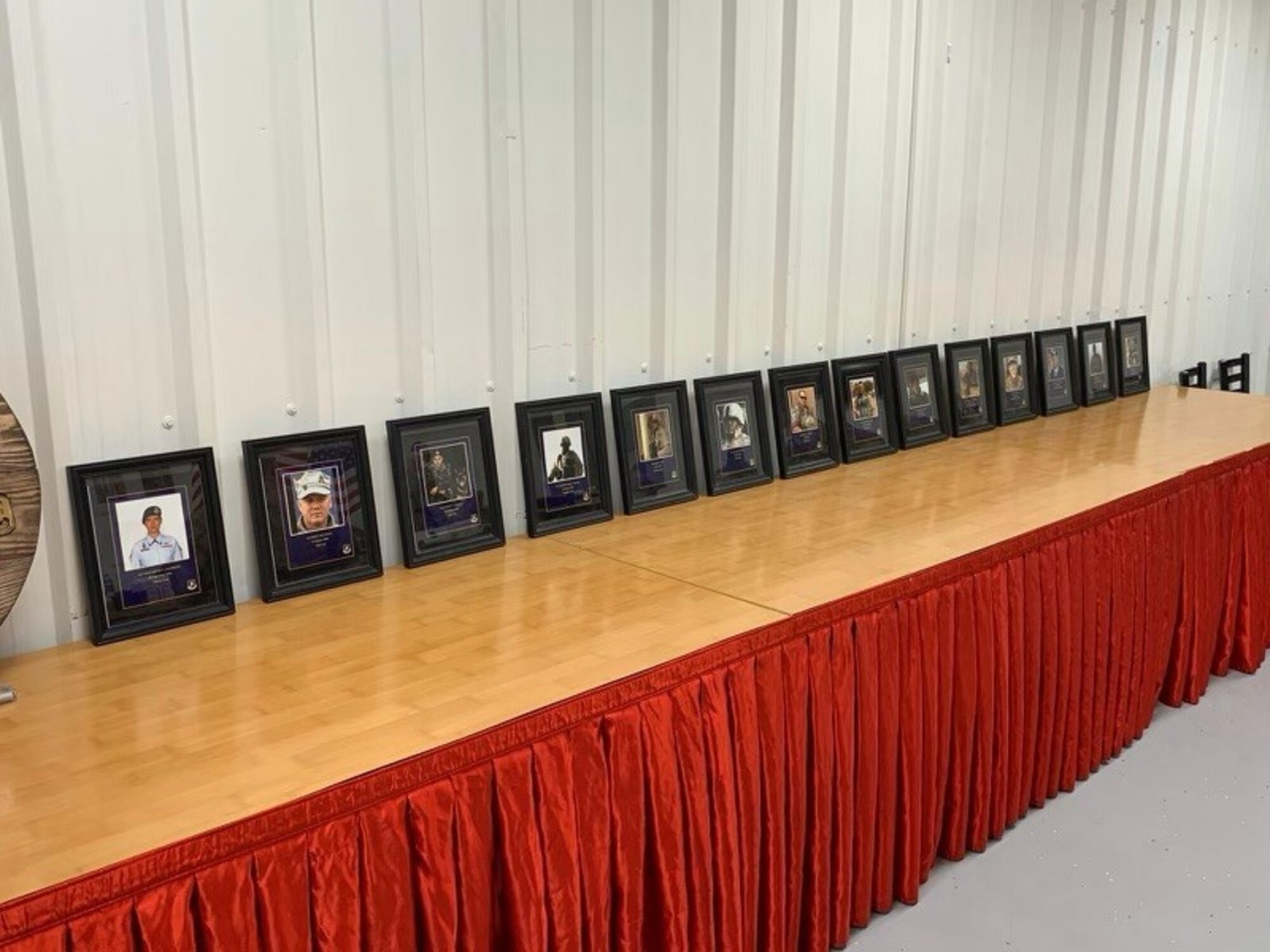 Framed photographs of Air Force Security Forces members killed in the line of duty since September 11, 2001 are on display, May 10, 2021 at Al Dhafra Air Base, United Arab Emirites. Tech. Sgt. Marvin Perez  volunteered to spearhead the 2021 Al Dhafra Air Base National Police Week opening breakfast. (U.S. Air national Guard photo by Master Sgt. Jessica Roy)