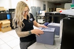 IMAGE: Lauren Sencio, Ship Self Defense System Hardware Design Task Planning Lead, checks the fit of the front plate of a 3D-printed arming unit May 25, at Naval Surface Warfare Center Dahlgren Division Dam Neck Activity in Virginia Beach, Virginia. The SSDS Hardware Design Team worked with DNA’s FIRE Lab to 3D print the arming unit—a component of the SSDS Command Control Group console—to speed up design validation for the prototype.