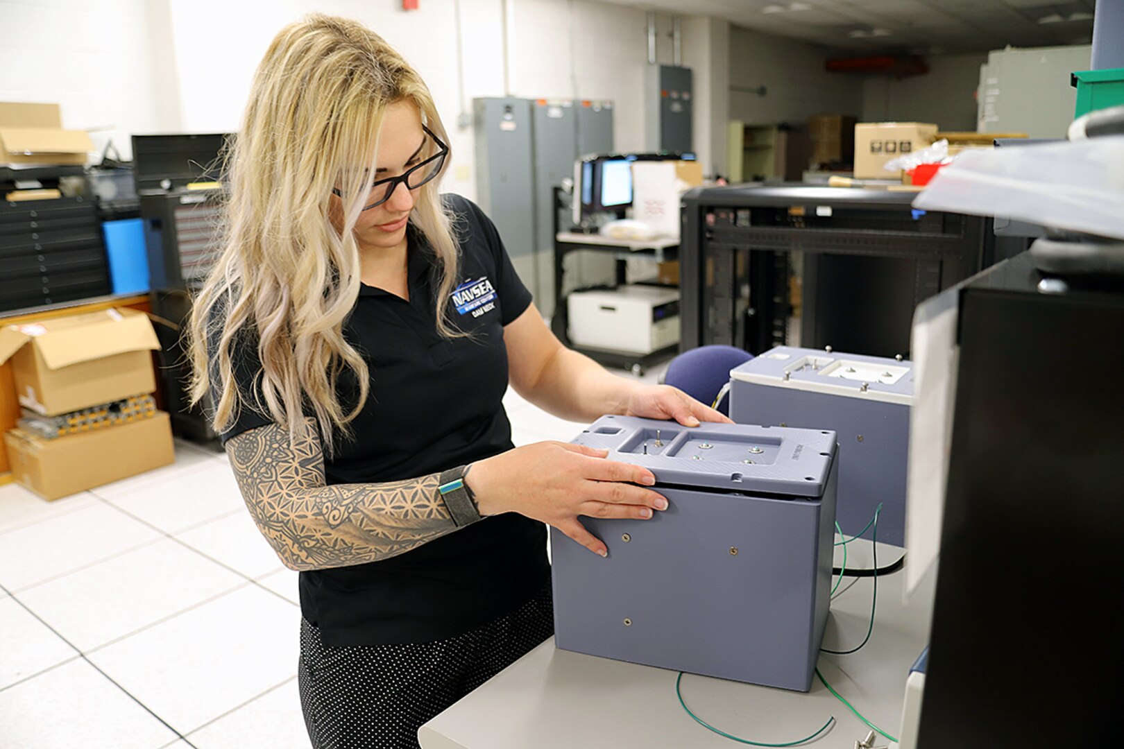 IMAGE: Lauren Sencio, Ship Self Defense System Hardware Design Task Planning Lead, checks the fit of the front plate of a 3D-printed arming unit May 25, at Naval Surface Warfare Center Dahlgren Division Dam Neck Activity in Virginia Beach, Virginia. The SSDS Hardware Design Team worked with DNA’s FIRE Lab to 3D print the arming unit—a component of the SSDS Command Control Group console—to speed up design validation for the prototype.