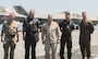 SICILY, Italy–  Gen. Kenneth McKenzie, commander, U.S. Central Command, center, poses for a photo with United Kingdom Carrier Strike Group leaders aboard HMS Queen Elizabeth June 14, 2021. Gen. McKenzie boarded the British Royal Navy ship from the Port of Augusta, the first in a series of port visits en route to the Mediterranean for the HMS Queen Elizabeth’s first operational deployment. The aircraft carrier launches F-35B Joint Strike Fighters operated and maintained by U.S. and British servicemembers.