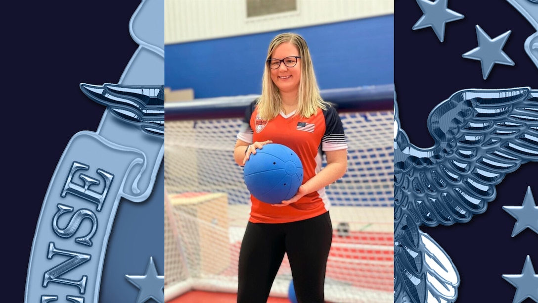 Mindy Cook holding one of the custom balls used in the paralympic sport of goalball.