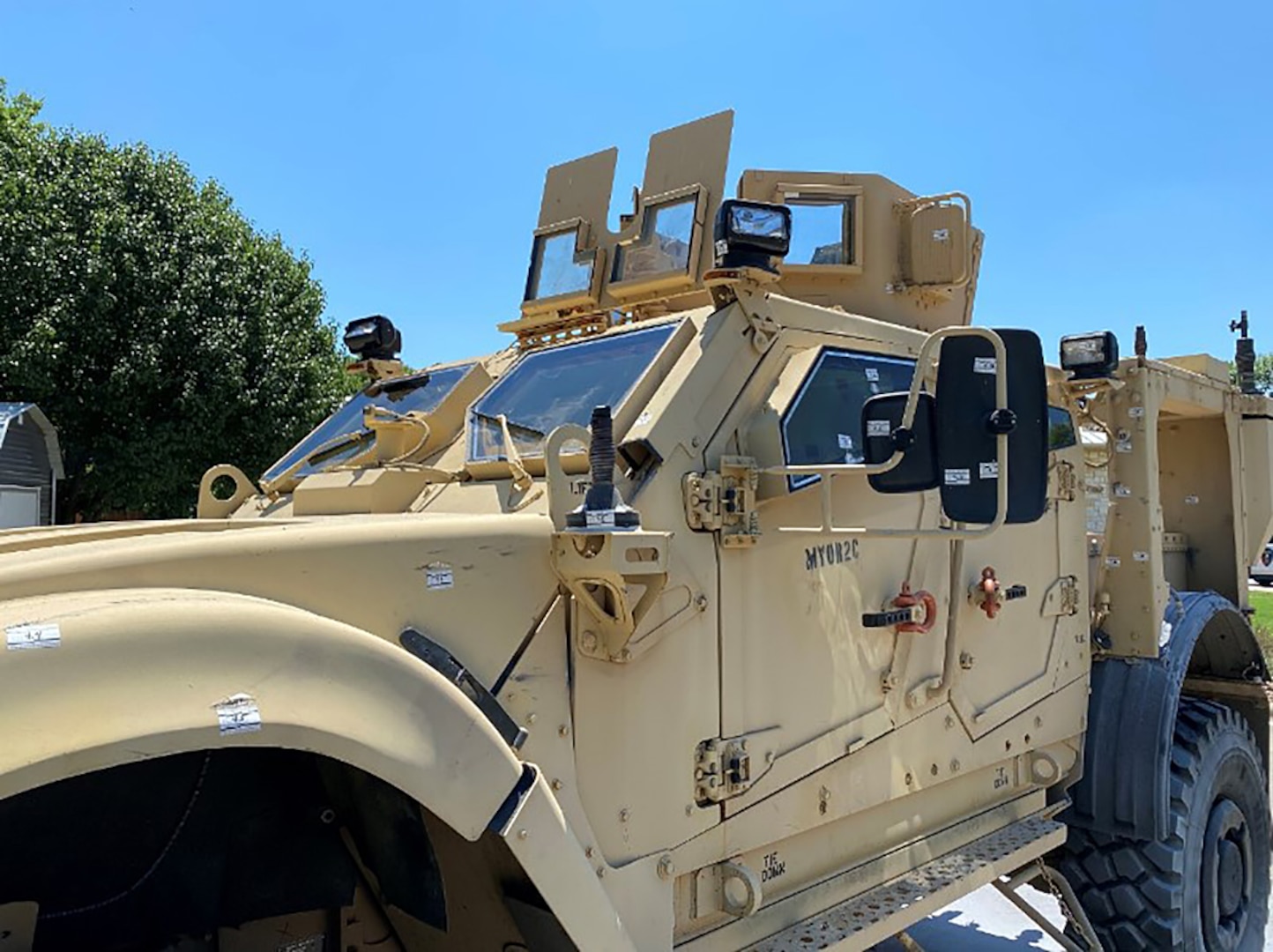 An MRAP with bullet marks.