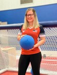 Mindy Cook holds a custom ball designed for the paralympic sport of goalball.
