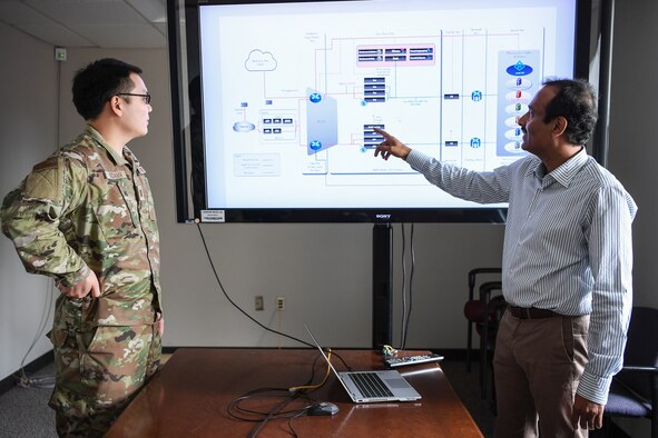 Raju Ranjan, an engineer from the AFNet Sustainment and Operations Branch discusses plans for a modern software-based perimeter with Capt. Christopher Kodama, a Branch engineer, at Hanscom Air Force Base, Mass., June 3.