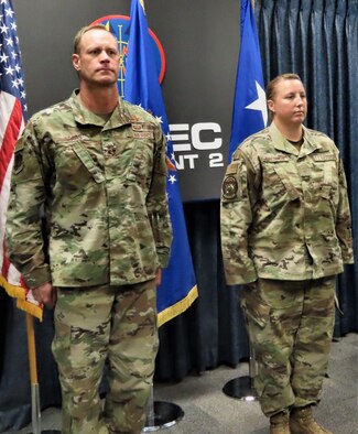 Air Force Operational Test and Evaluation Center Commander Maj. Gen. James R. Sears Jr., and Master Sgt. Michelle Bresson stand at attention while the Bronze Star Medal citation is read. Master Sgt. Bresson is assigned to AFOTEC's Detachment 5 Operating Location at Hurlburt Field, Fla., as a Special Missions Aviator for the MH-139 multi-mission helicopter operational test team.