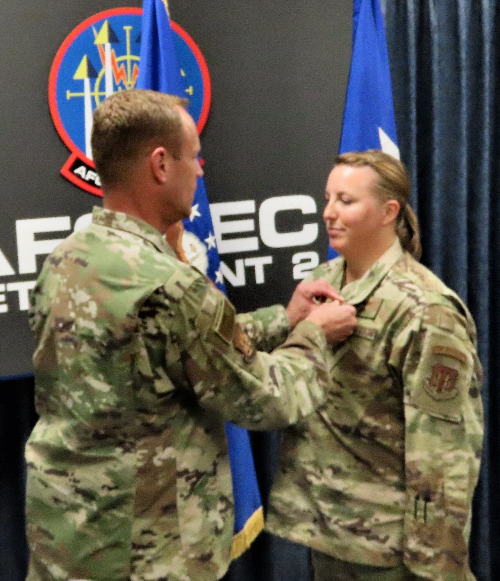 Air Force Operational Test and Evaluation Center Commander Maj. Gen. James R. Sears Jr., pins the Bronze Star Medal on Master Sgt. Michelle Bresson for her actions as an Air Advisor while deployed to Kandahar Airfield, Afghanistan. (U.S. Air Force photo by Chris Whitman)