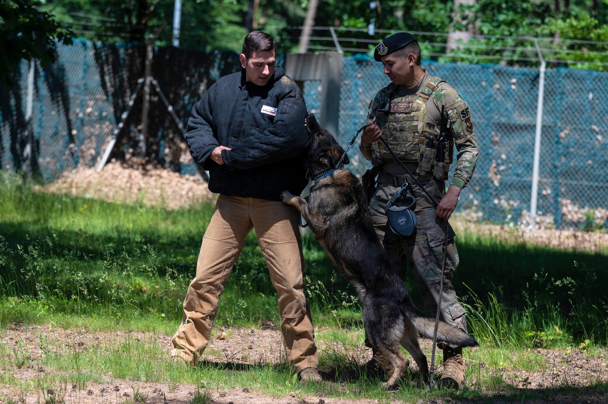 U.S. Air Force Staff Sgt. Gabriel Santiago, 86th Security Forces Squadron military working dog handler, right, and his military working dog, Arthur, practice bite work