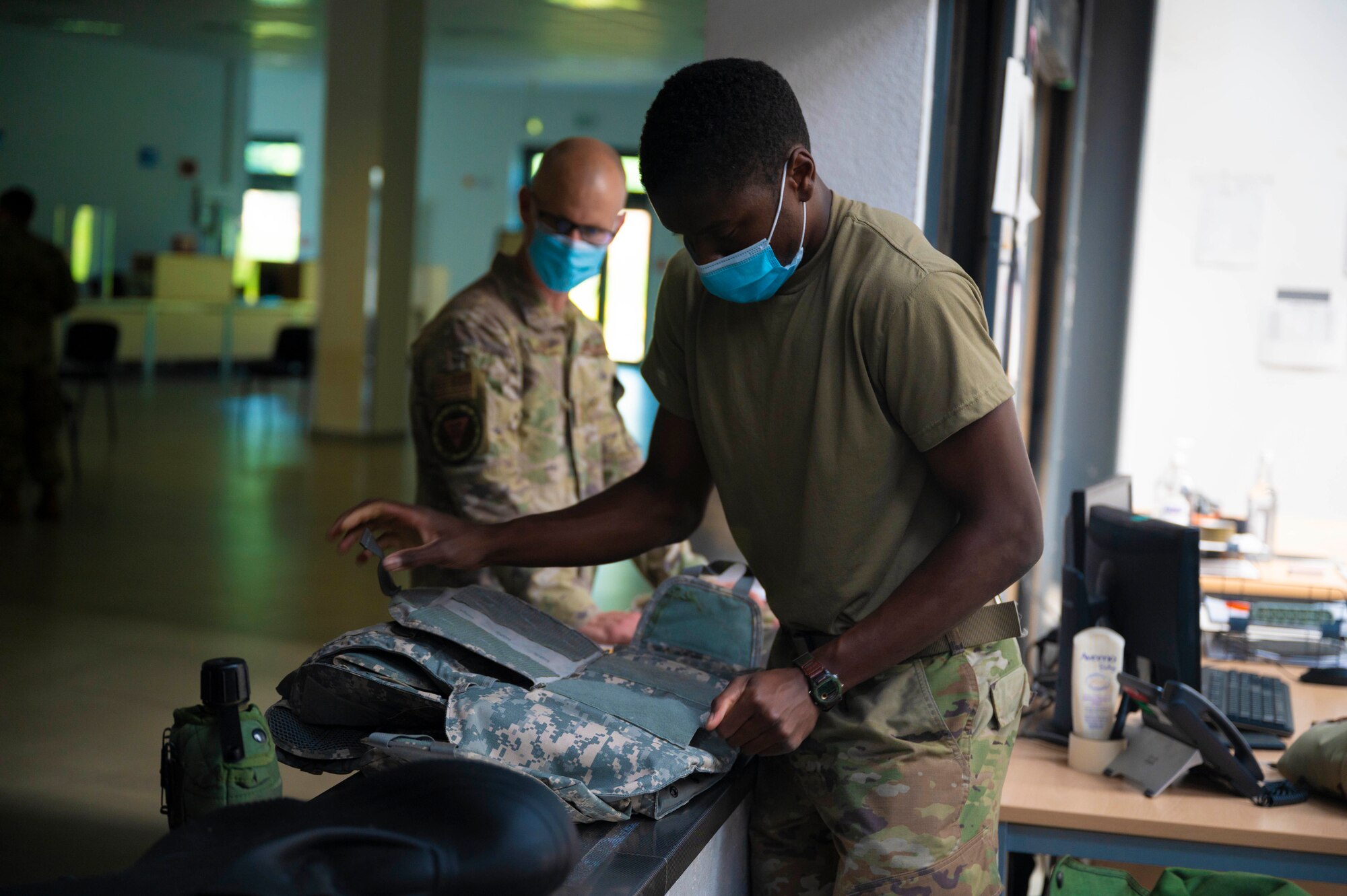 U.S. Air Force Airman 1st Class Kamil Jackson, 86th Logistics Readiness Squadron individual protective equipment journeyman, inspects returned IPE