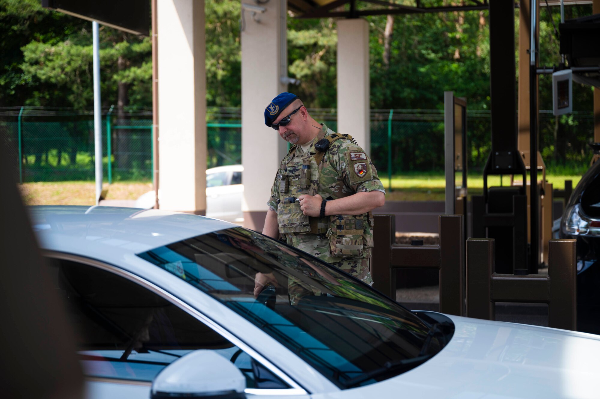 A patrolman assigned to the 86th Security Forces Squadron conducts a security check of vehicles entering Ramstein Air Base