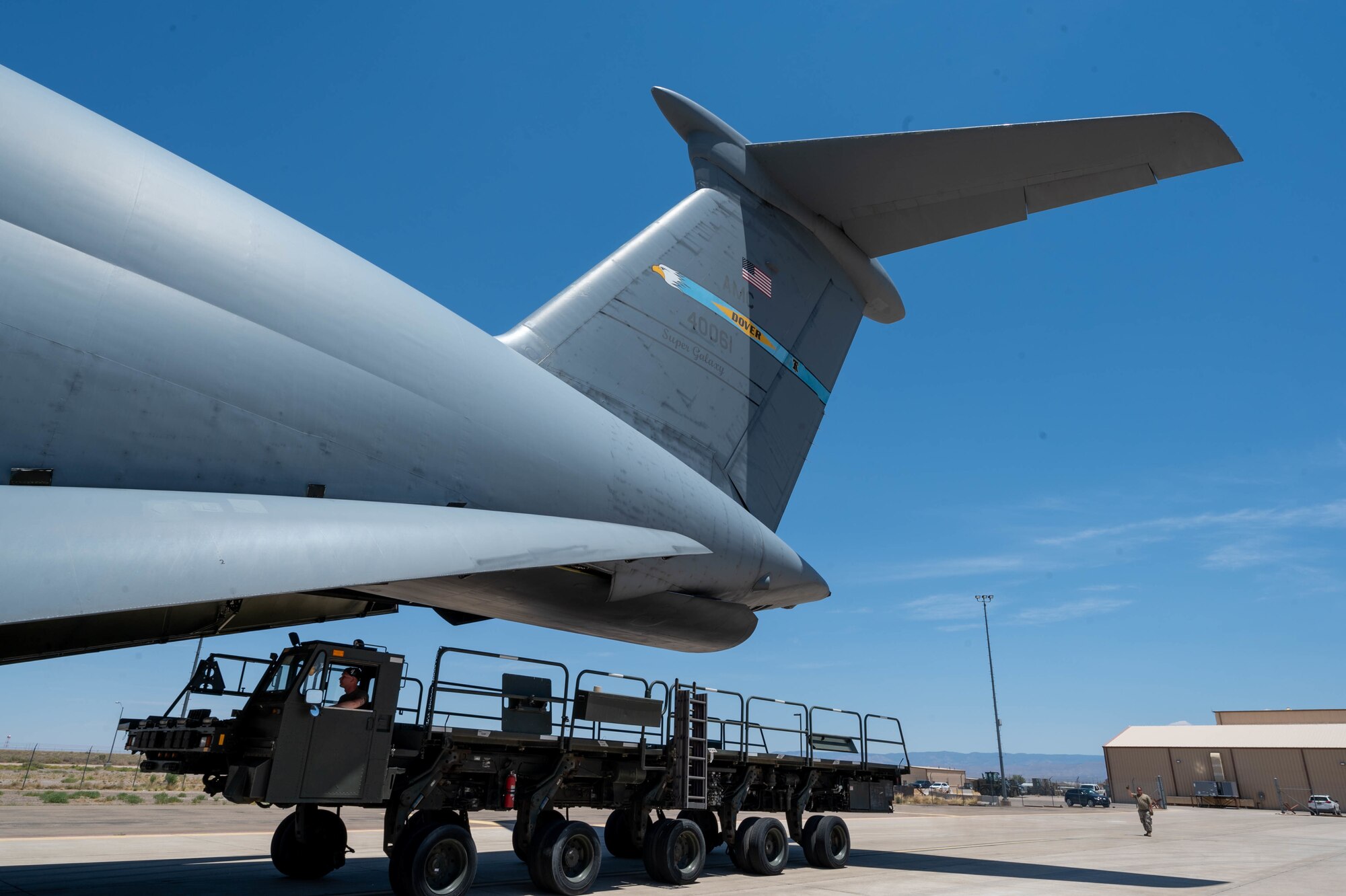 A K-loader is loaded onto a Dover Air Force Base C-5M Super Galaxy during a Major Command Service Tail Trainer at Holloman AFB, New Mexico, June 9, 2021. Loadmasters from the 9th Airlift Squadron coordinated cargo with Airmen from the 49th Wing and 635th Materiel Maintenance Group to complete the 10-day MSTT. Over the course of the training, Airmen loaded and unloaded 320,085 pounds of cargo, including palletized cargo, aircraft ground equipment, a fuel truck and a K-loader. (U.S. Air Force photo by Senior Airman Faith Schaefer)