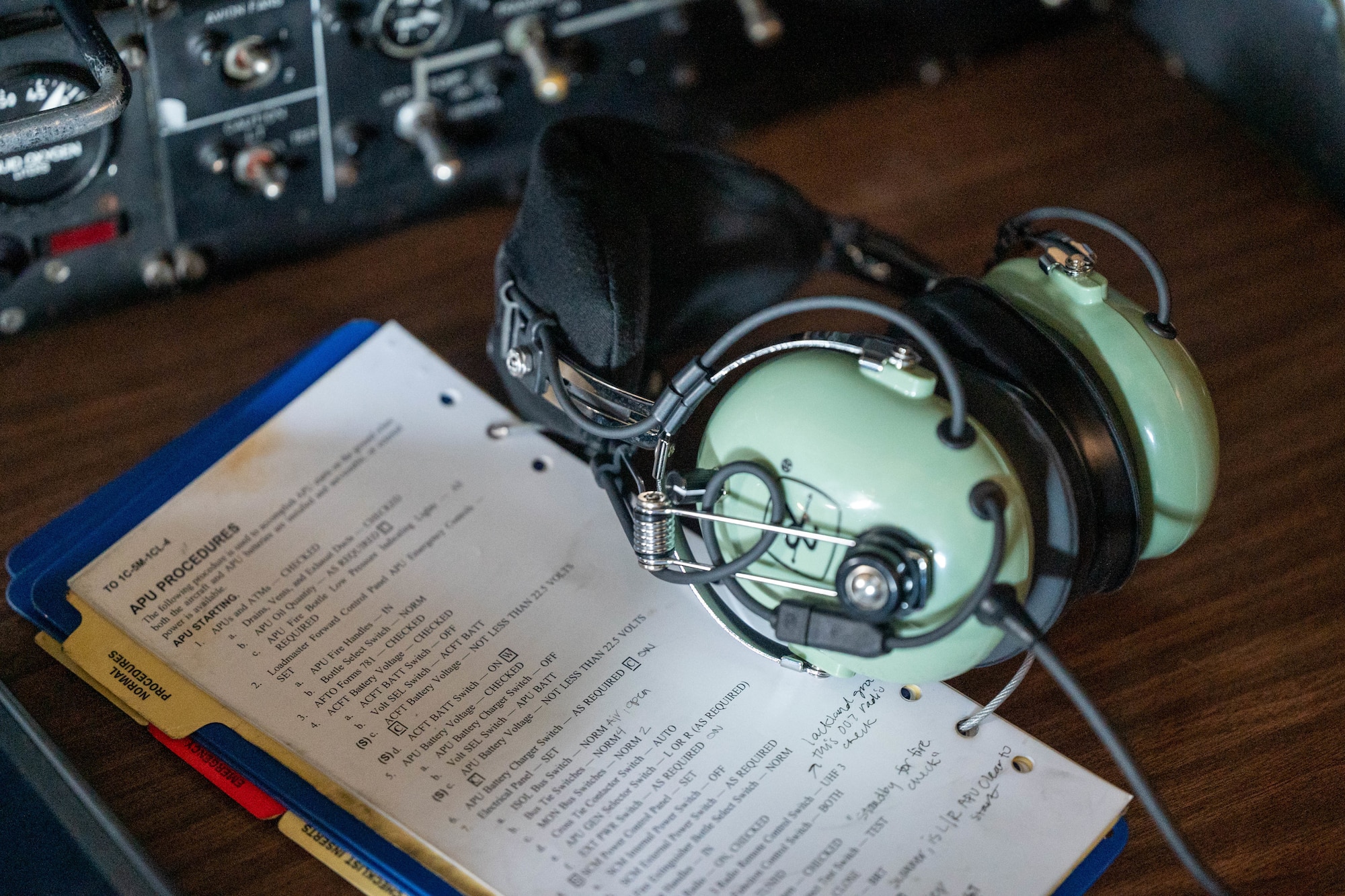 An auxiliary power unit checklist and an aviation headset rest on the flight deck of a Dover Air Force Base C-5M Super Galaxy during a Major Command Service Tail Trainer at Holloman AFB, New Mexico, June 8, 2021. Following an initiative from Air Mobility Command, MSTTs have been in the training plan of the 9th Airlift Squadron since early 2021 to expedite upgrade and qualification training for C-5M Super Galaxy loadmasters and flight engineers. Of the 350 tasks needed to be a fully qualified loadmaster, roughly half can be completed during an MSTT. (U.S. Air Force photo by Senior Airman Faith Schaefer)