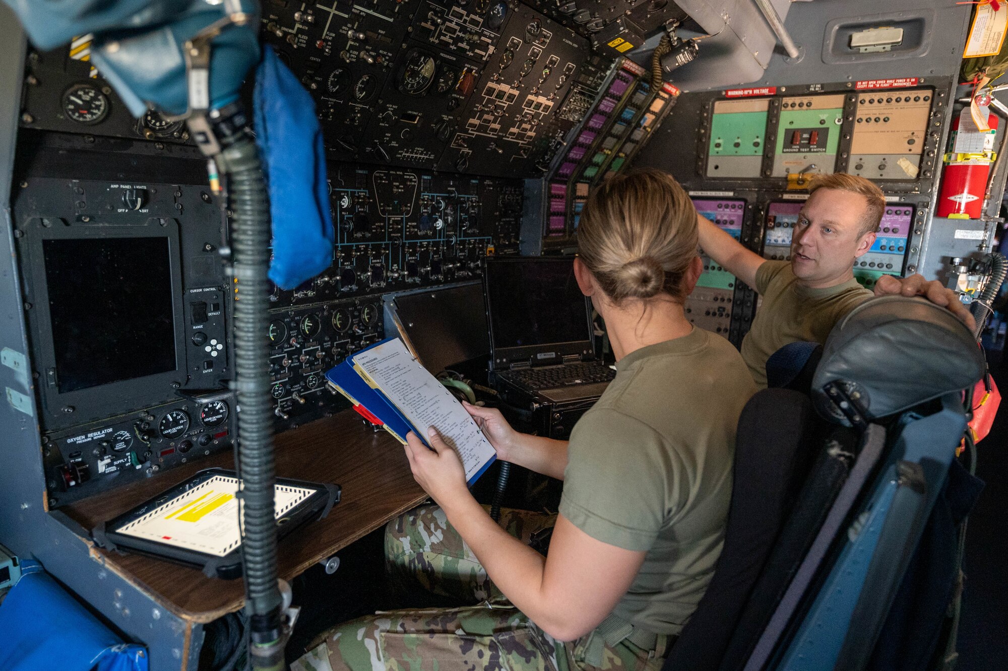 Airman 1st Class Rebecca Reimer, 9th Airlift Squadron loadmaster student, and Staff Sgt. Justin Thomas, 9th AS noncommissioned officer in charge of loadmaster training, discuss procedures for turning on the auxiliary power units on a Dover Air Force Base C-5M Super Galaxy during a Major Command Service Tail Trainer at Holloman AFB, New Mexico, June 8, 2021. This MSTT was coordinated in partnership with Air Education Training Command’s 49th Wing and Air Force Materiel Command’s 635th Material Maintenance Group. (U.S. Air Force photo by Senior Airman Faith Schaefer)