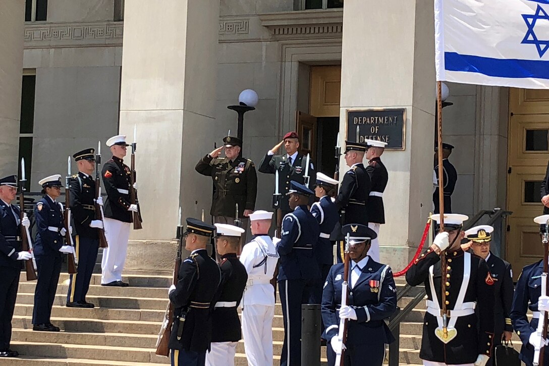 Two generals salute at the steps of the Pentagon.