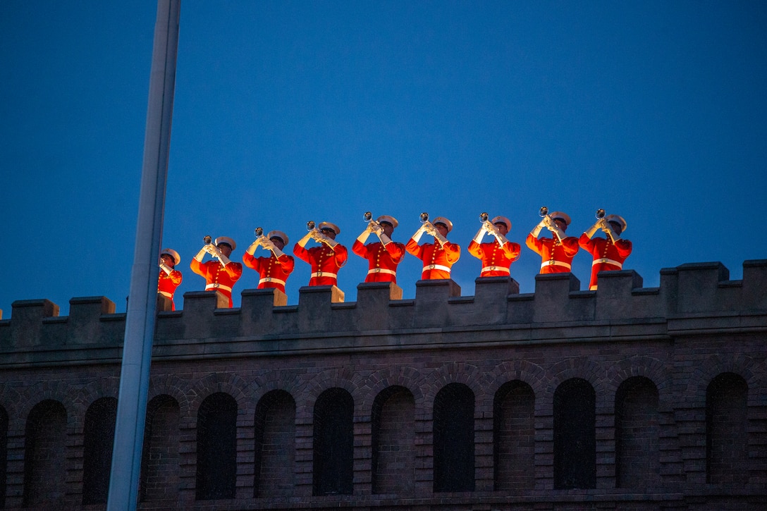 Marines with “The Commandant’s Own,” U.S. Marine Drum and Bugle Corps perform “fanfare” on the ramparts during a Friday Evening Parade at Marine Barracks Washington, June 18, 2021. U.S. Marine Corps Lt. Gen. George W. Smith Jr., Deputy Commandant for Plans, Policies and Operations, was the hosting official and U.S. Army General Paul M. Nakasone, USA Commander of United States Cyber Command, Director of the National Security Agency and Chief of the Central Security Service, was the guest of honor. (U.S. Marine Corps photo by Lance Cpl. Mark Morales)