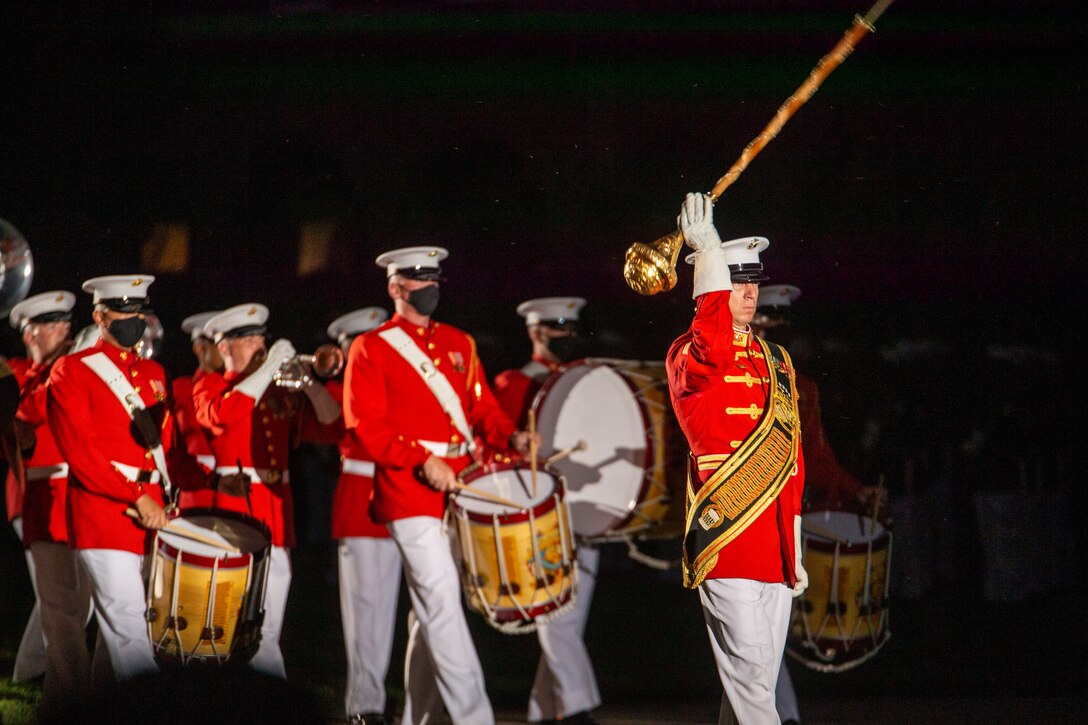 Master Sgt. Joshua Dannemiller, assistant drum major, “The Commandant’s Own,” U.S. Marine Drum and Bugle Corps, leads members of the Drum and Bugle Corps through “slow march”  during a Friday Evening Parade at Marine Barracks Washington, June 18, 2021. U.S. Marine Corps Lt. Gen. George W. Smith Jr., Deputy Commandant for Plans, Policies and Operations, was the hosting official and U.S. Army General Paul M. Nakasone, USA Commander of United States Cyber Command, Director of the National Security Agency and Chief of the Central Security Service, was the guest of honor. (U.S. Marine Corps photo by Lance Cpl. Mark Morales)