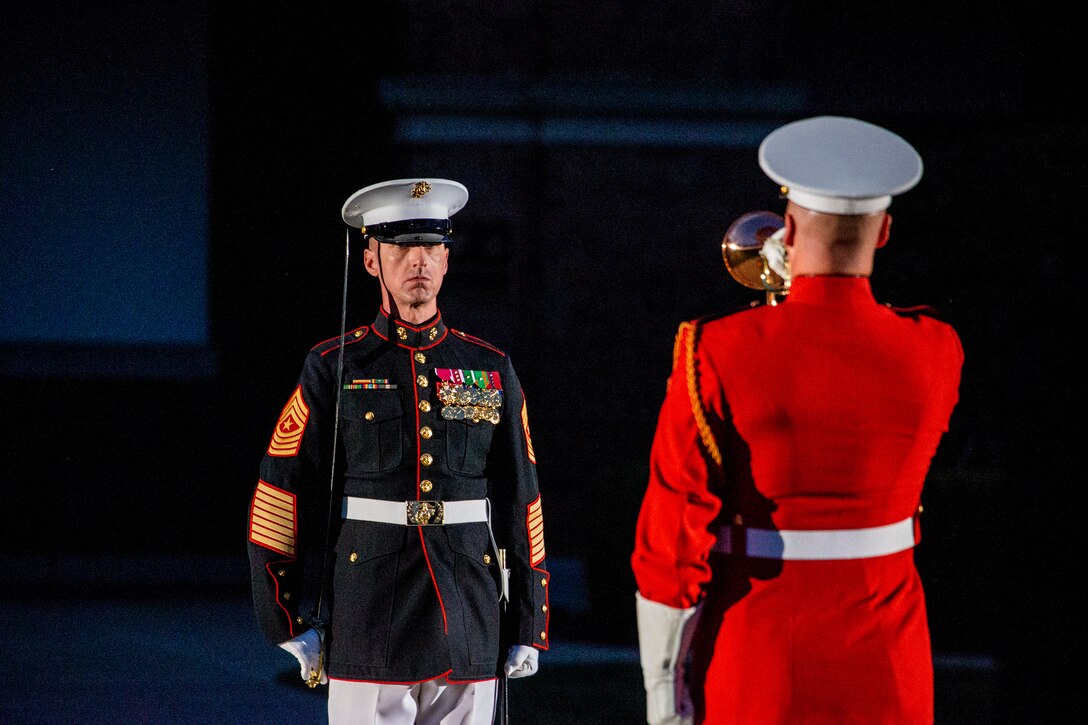 Sergeant Maj. Adrian L. Tagliere, sergeant major, Marine Barracks Washington, and Staff Sgt. Christopher Walker, ceremonial bugler, “The Commandant’s Own” United States Marine Drum and Bugle Corps, perform during a Friday Evening Parade at Marine Barracks Washington, June 18, 2021. U.S. Marine Corps Lt. Gen. George W. Smith Jr., Deputy Commandant for Plans, Policies and Operations, was the hosting official and U.S. Army General Paul M. Nakasone, USA Commander of United States Cyber Command, Director of the National Security Agency and Chief of the Central Security Service, was the guest of honor. (U.S. Marine Corps photo by Lance Cpl. Allen Sanders)