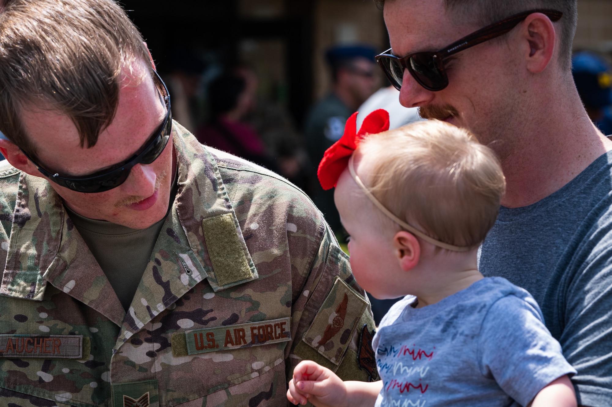 A photo of an Airman talking to a child