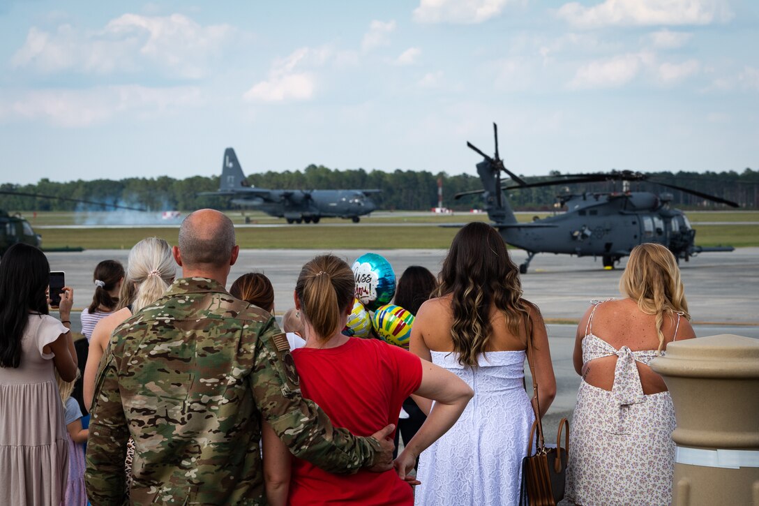 A photo of people watching an aircraft land
