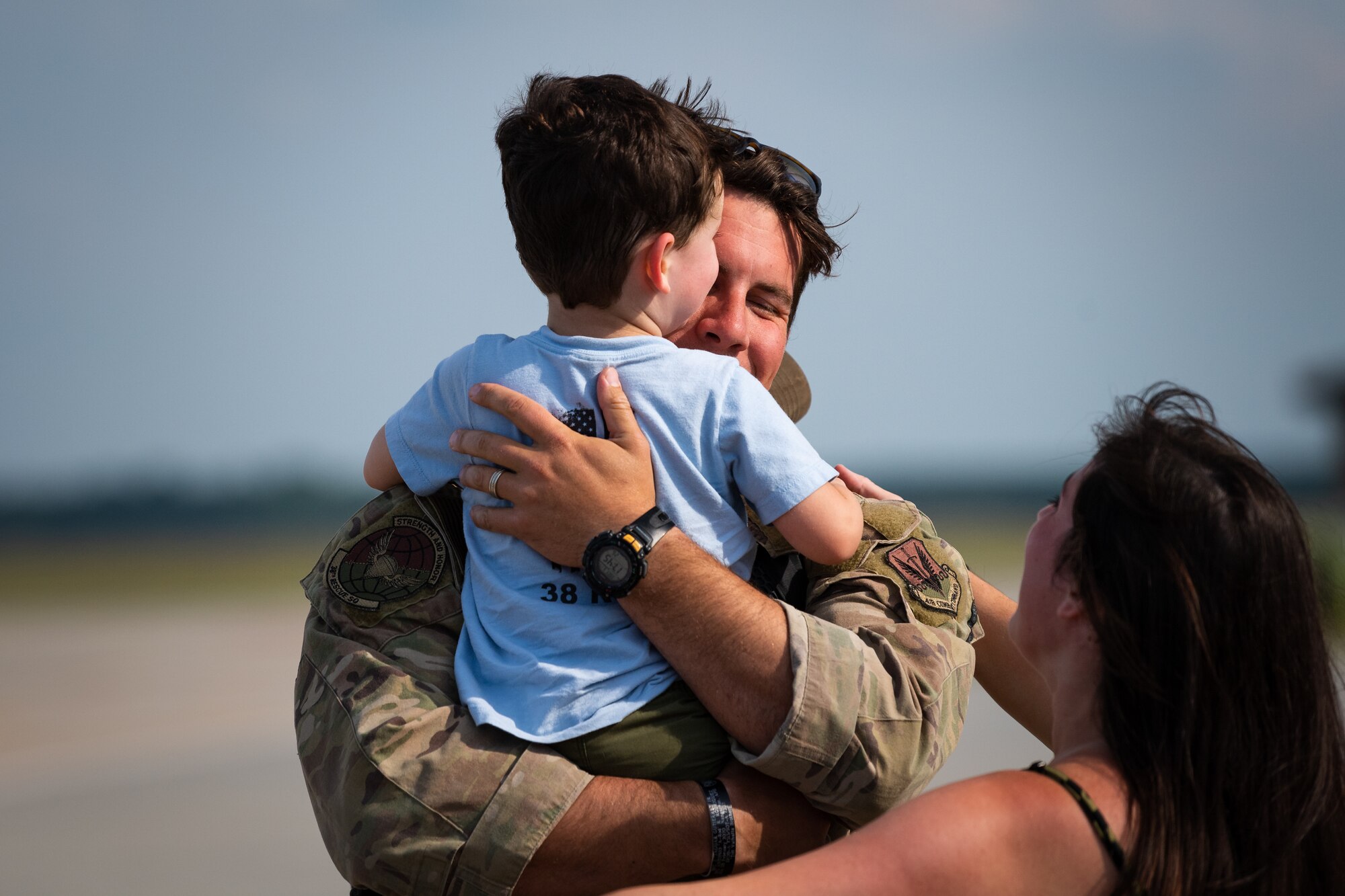 A photo of an Airman hugging a child