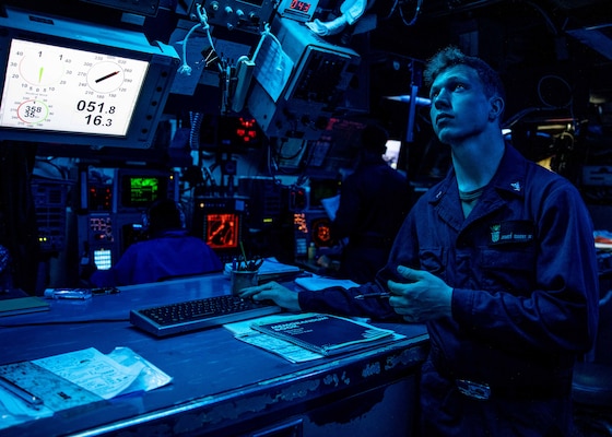 Fire Controlman (Aegis) 3rd Class James Eisert, from Philadelphia, stands watch in combat systems while Arleigh Burke-class guided-missile destroyer USS Curtis Wilbur (DDG 54) as the ship conducts routine operations.