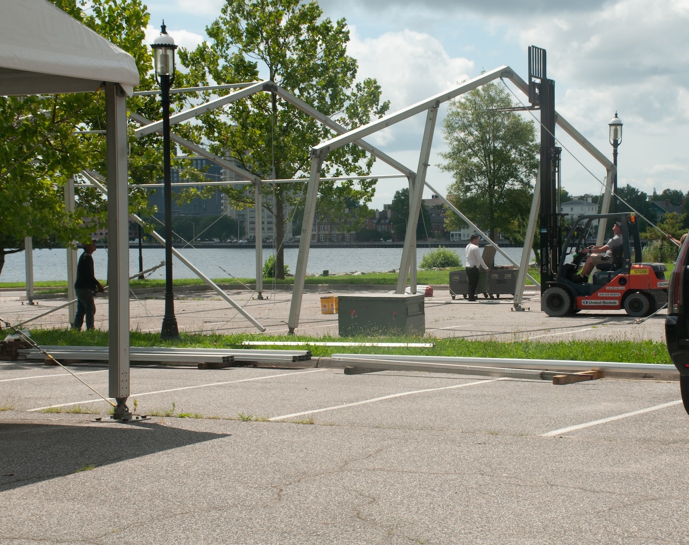 Workers take apart COVID-19 testing tents, June 15, which were put up in March 2020 to provide car triage screening for the virus.