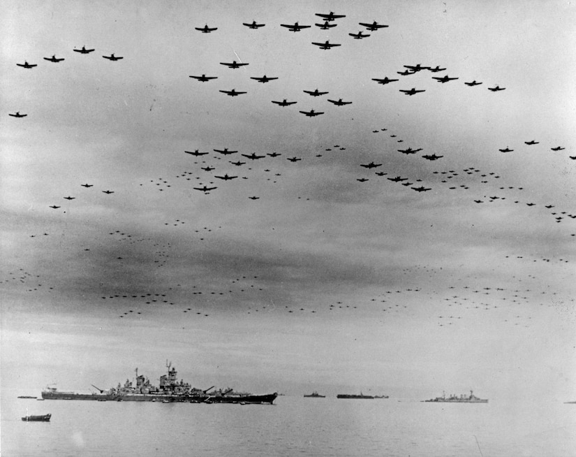 Ships and planes maneuver at sea.