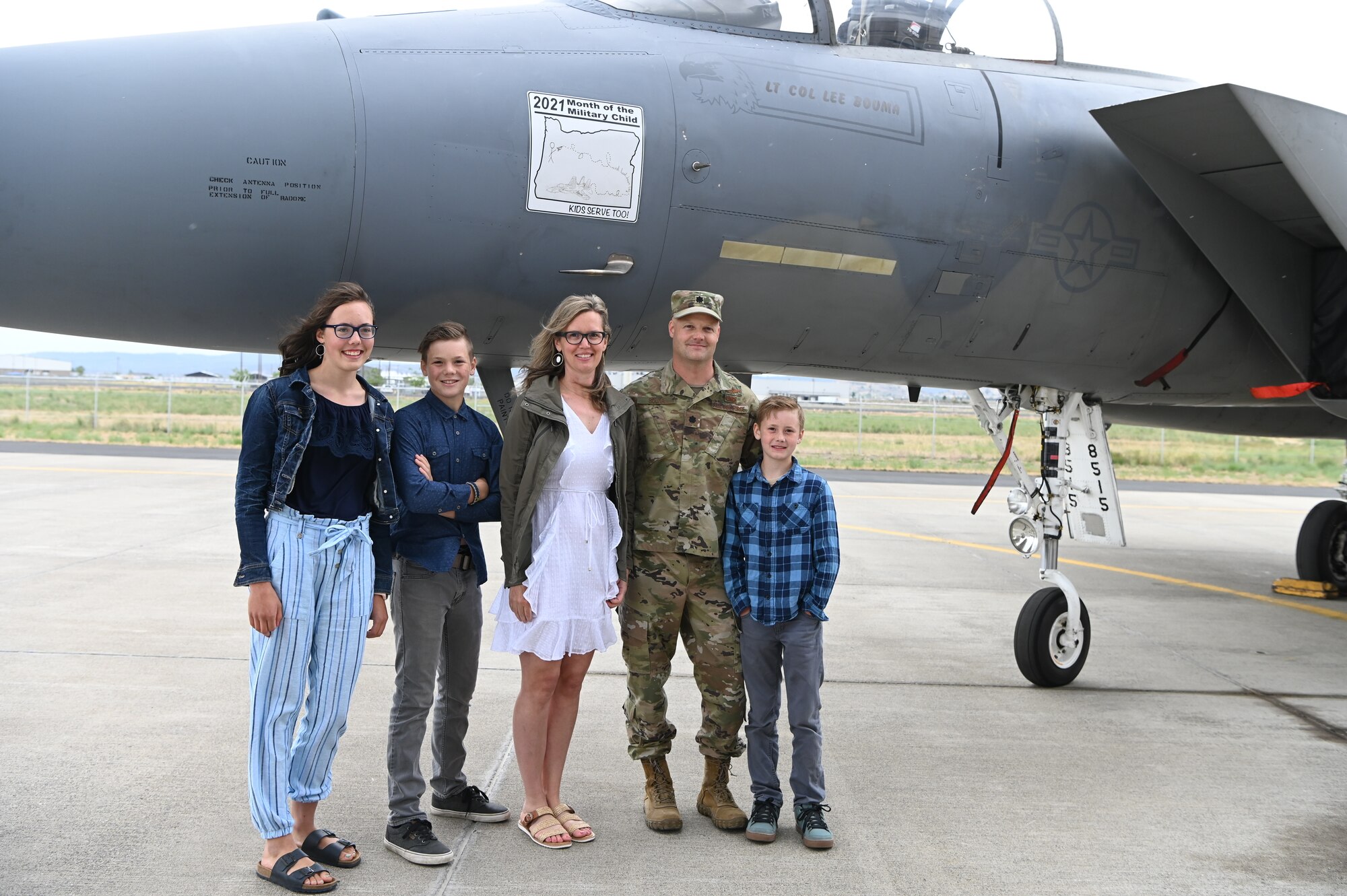 Child poses in front of F-15 Eagle