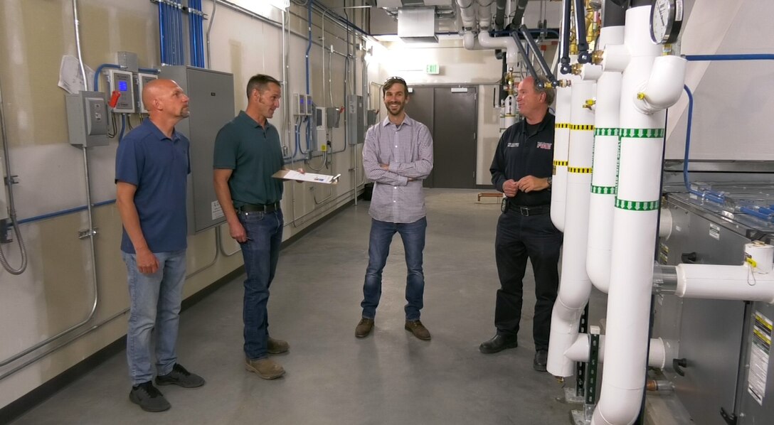 Members from the USACE, Omaha District’s Fort Carson South office (from left) Dan Morak, Justin Scherzberg, Ken Hombostel, and Fort Carson fire inspector,Rob Wurchner,check a mechanical room during a post-construction walk through May 19.