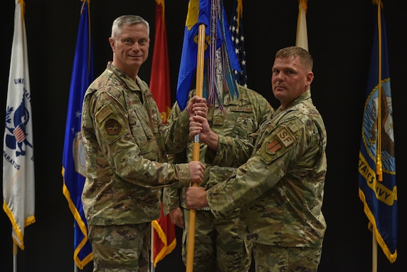 U.S. Air Force Col. Tony England, 17th Mission Support Group commander, takes the guidon from Lt. Col. Richard Buckley, outgoing 17th Security Forces Squadron commander, during the change of command ceremony at the Event Center on Goodfellow Air Force Base, Texas, June 22, 2021. Buckley is taking a position at the Air Force Security Forces Center at Lackland AFB. (U.S. Air Force photo by Senior Airman Ashley Thrash)