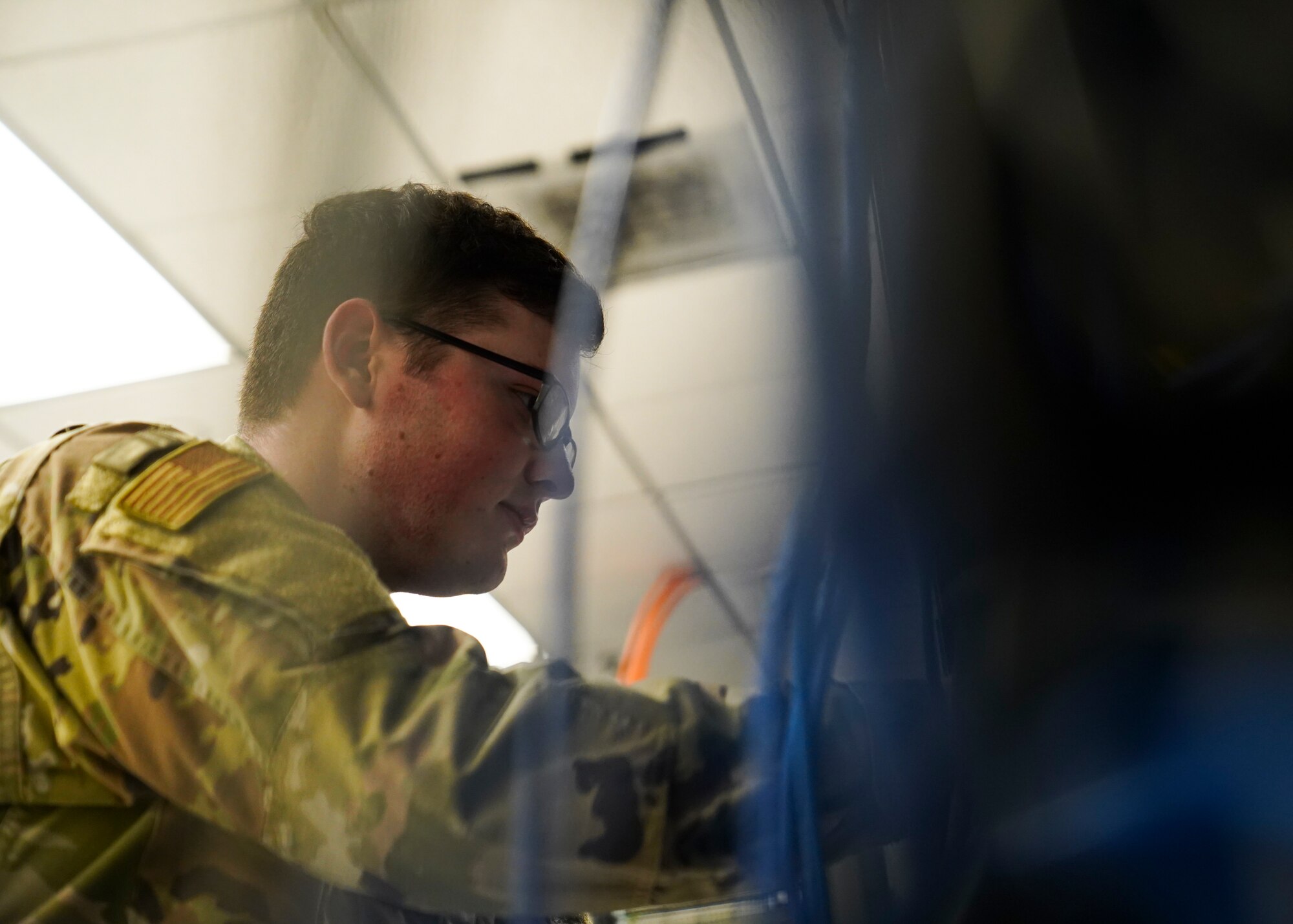 U.S. Air Force Senior Airman Logan Skinner, 81st Communications Squadron client systems technician, checks a cable wall inside the 81st CS building at Keesler Air Force Base, Mississippi, June 15, 2021. The 81st CS provides a network control center capability, including a client service center, network management, server administration and network information assurance services to 10,000 users on Keesler. (U.S. Air Force photo by Senior Airman Spencer Tobler)