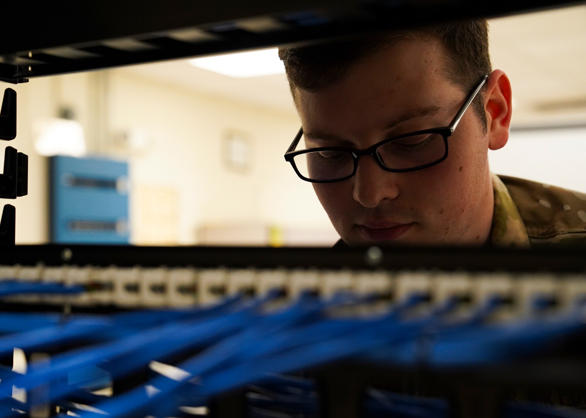 U.S. Air Force Senior Airman Logan Skinner, 81st Communications Squadron client systems technician, checks a cable wall inside the 81st CS building at Keesler Air Force Base, Mississippi, June 15, 2021. The 81st CS provides a network control center capability, including a client service center, network management, server administration and network information assurance services to 10,000 users on Keesler. (U.S. Air Force photo by Senior Airman Spencer Tobler)