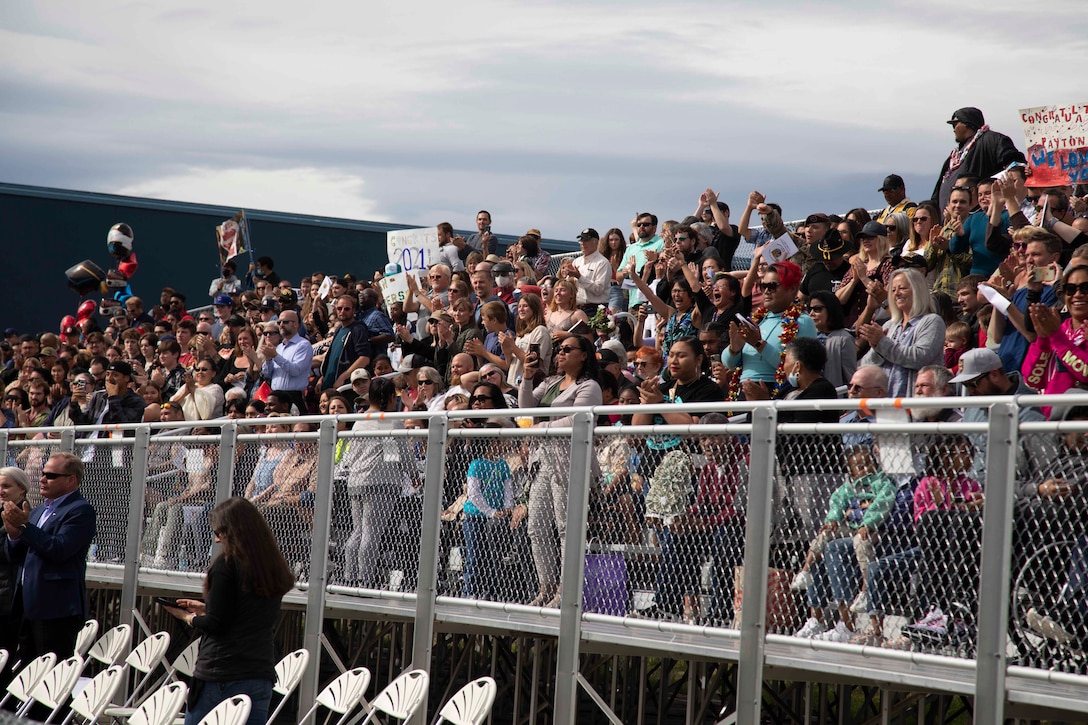 Family and friends recieve the graduating cadets with applause at the Alaska Military Youth Academy graduation ceremony, held at the Bartlett High School Football Field in Anchorage, June 18, 2021. The ceremony featured Alaska Lt. Gov. Kevin Meyer as the keynote speaker for the 79 graduating cadets and their families. (U.S Army National Guard photo by Victoria Granado)