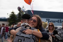 An Alaska Military Youth Academy cadet embraces his family after AMYA's graduation ceremony, held at the Bartlett High School Football Field in Anchorage, June 18, 2021. The ceremony featured Alaska Lt. Gov. Kevin Meyer as the keynote speaker for the 79 graduating cadets and their families. (U.S Army National Guard photo by Victoria Granado)