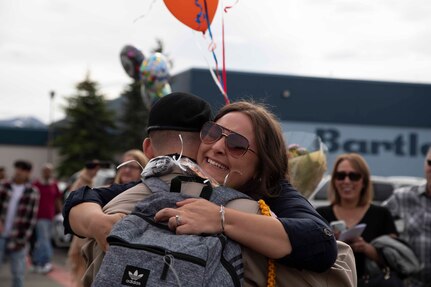 An Alaska Military Youth Academy cadet embraces his family after AMYA's graduation ceremony, held at the Bartlett High School Football Field in Anchorage, June 18, 2021. The ceremony featured Alaska Lt. Gov. Kevin Meyer as the keynote speaker for the 79 graduating cadets and their families. (U.S Army National Guard photo by Victoria Granado)