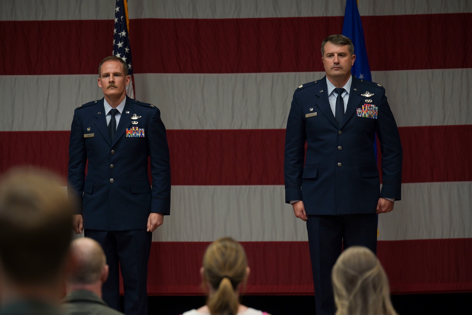 U.S. Air Force Col. Justin Spears, 14th Operations Group commander and Lt. Col. Joseph McCane, outgoing 14th Student Squadron commander, stand at attention as McCane is presented the Meritorious Service Medal, during a change of commander ceremony, June 21, 2021, on Columbus Air Force Base, Miss. McCane directed over 22,000 T-1 sorties and led the graduation of 285 T-1 students. (U.S. Air Force photo by Airman 1st Class Jessica Haynie)